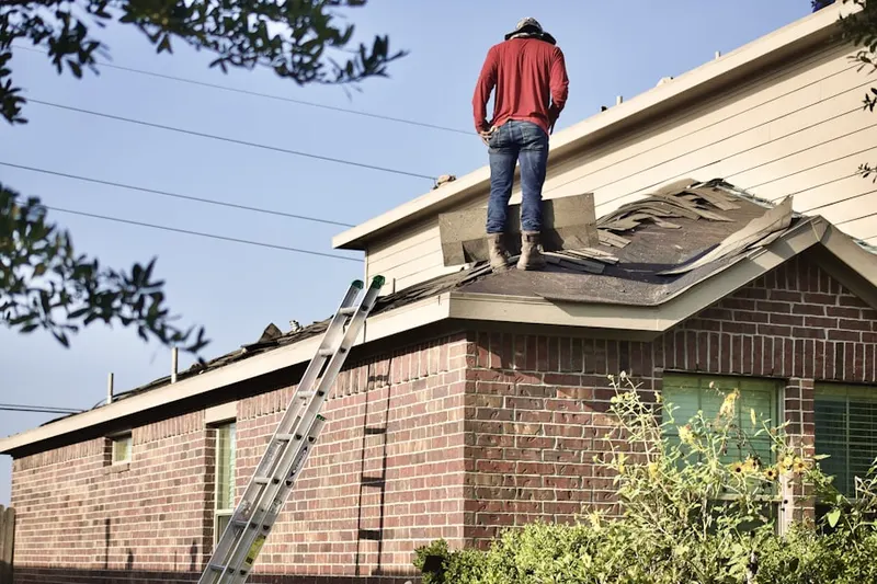 Professional roofer working on a residential roof in Toms River